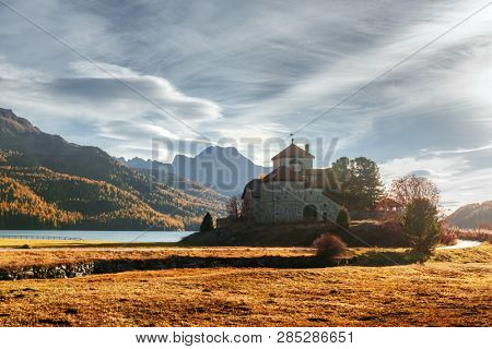 Amazing autumn sunny day at Champferersee lake in the Swiss Alps. Castle of Crap da Sass, Silvaplana village, Switzerland, Europe