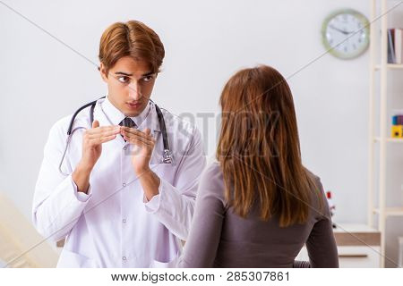 Deaf-mute female patient visiting young male doctor 