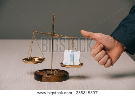 Partial View Of Businessman Showing Thumbs Up Near Scales Of Justice And Male Signs, Gender Stereoty