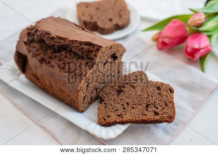 Home Made Chocolate Cake With Tulips On An Easter Table