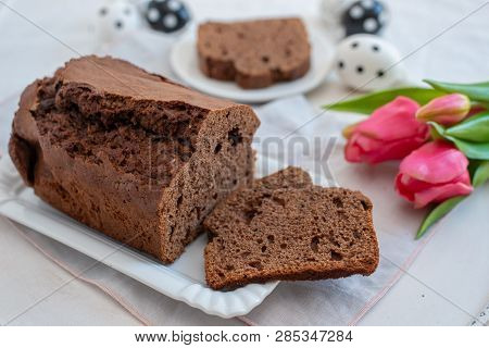 Home Made Chocolate Cake With Tulips On An Easter Table