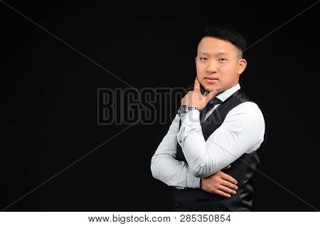 Asian Young Man Looks At The Camera, Put His Hand To Face, Turned Sideways