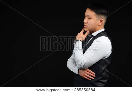 Asian Young Man Looks Away, Put His Hand To Face, Turned Sideways