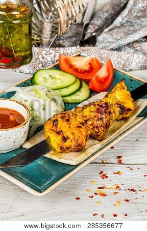Skewers, Onions, Pita Bread, Sauce On A White Plate