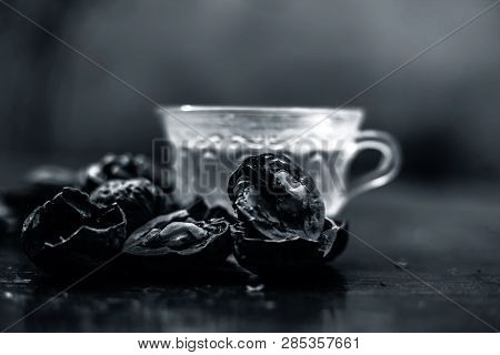 Close Up Of Herbal Organic Tea Of Wall Nut Or Walnut Tea In A Transparent Glass Cup With Raw Wall Nu