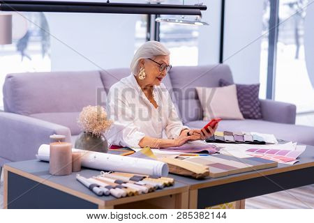 Smashing Good-appealing High Manager Checking Her Schedule In Phone