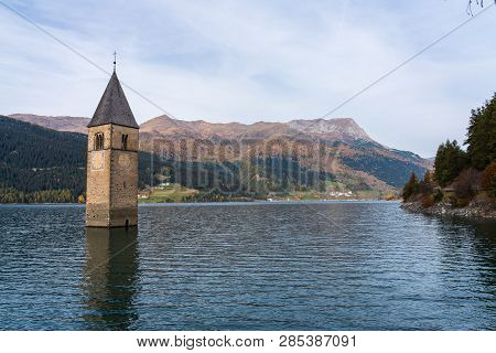 The Famous Bell Tower In The Lake Of Reschen - Lago Di Resia In South Tyrol, Italy. During Ww2 A Dam