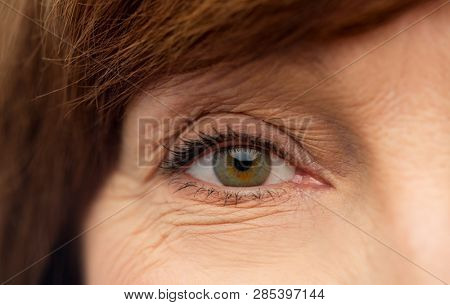 beauty, vision and old people concept - eye of senior woman
