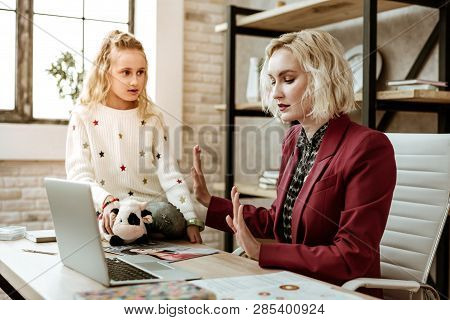Serious Resolute Woman In Red Jacket Showing Insufferable Gesture