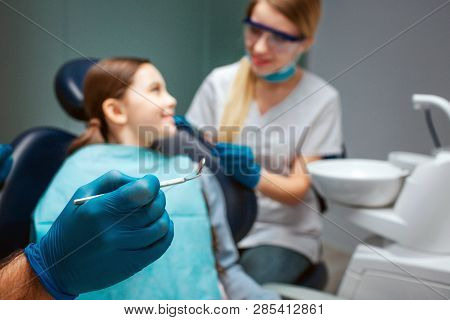 Hand In Latex Glove Hold Dental Tool Hold Dental Tool. Child Sit In Chair And Smile To Woman. Female