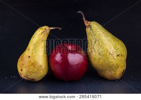 One Apple And Two Pears On Darc Background. Homegrown Organic Fruits.