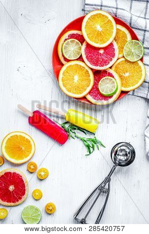Citrus Popsicles With Fruit Slices On Stone Background Top View