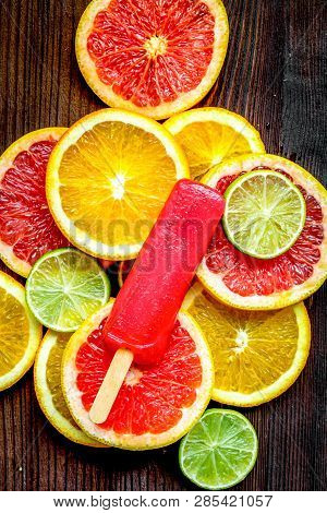 Citrus Slices With Fruit Popsicles On Table Background Top View