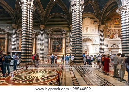 Siena, Italy - Sep 22: Tourists Watching Interior Of 14th Century Duomo Di Siena With Mosaics And De