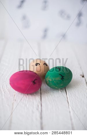 Easter Eggs On A White Wooden Background.