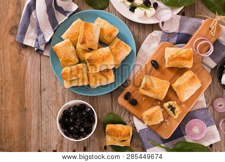 Spinach Puffs With Feta Cheese On Cuttingboard.