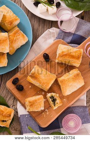 Spinach Puffs With Feta Cheese On Cuttingboard.