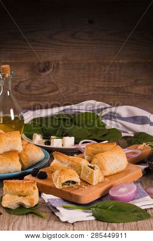 Spinach Puffs With Feta Cheese On Cuttingboard.