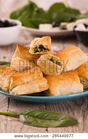 Spinach Puffs With Feta Cheese On Cuttingboard.