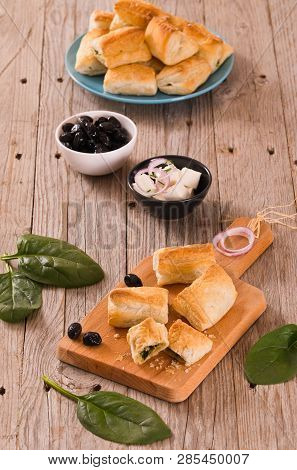 Spinach Puffs With Feta Cheese On Cuttingboard.
