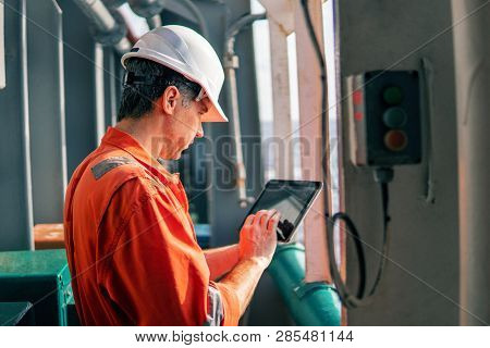 Chief Officer Or Captain On Deck Of Vessel Or Ship Watching Digital Tablet