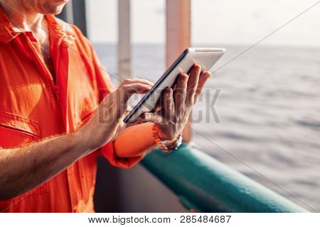 Chief Officer Or Captain On Deck Of Vessel Or Ship Watching Digital Tablet