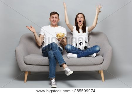 Excited Couple Woman Man Football Fans Cheer Up Support Favorite Team With Soccer Ball, Holding Bowl