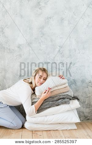 Pillow Comfort. Quality Bedding Coziness. Young Woman Sleeping On Pile Of Pillows. Copy Space On Gre