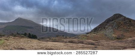 Dark And Dramatic Winter Landscape Image Of Moel Saibod From Crimpiau In Snowdonia With Stunning Sha