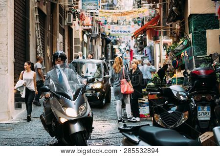 Naples, Italy - October 17, 2018: Man Riding On Scooter At Vico Lungo Del Gelso Street. Traffic On F