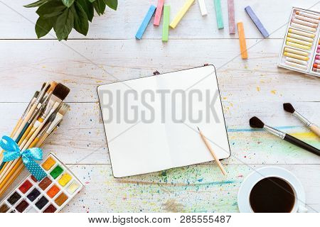Colorful Creative Table With Blank Notebook For Sketches And Paints, Pencil, Paintbrushes Set And Cu