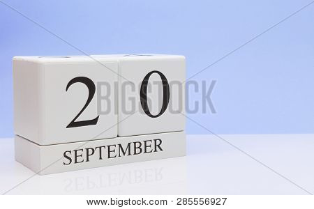 September 20st. Day 20 Of Month, Daily Calendar On White Table With Reflection, With Light Blue Back