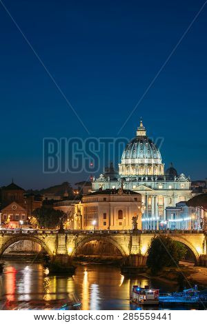 Rome, Italy. Papal Basilica Of St. Peter In The Vatican And Aelian Bridge In Evening Night Illuminat