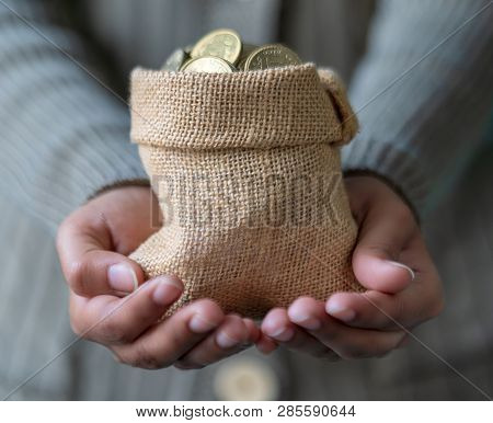 Sack Of Indian Coins In Hand