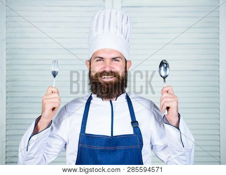 Chef Happy Smiling Face Hold Spoon And Fork. Man Handsome With Beard Holds Kitchenware On White Back