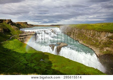 Tourists at the Gullfoss (Golden Falls) waterfall on the HvÃ­tÃ¡ river, a popular tourist attraction and part of the Golden Circle Tourist Route in Southwest Iceland, Scandinavia