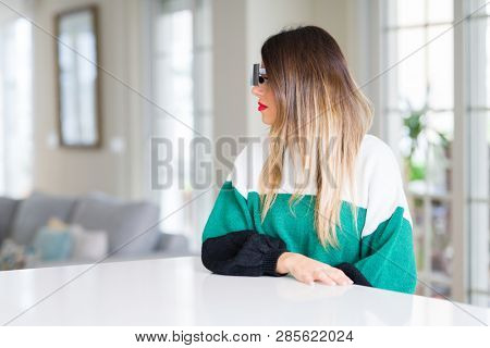 Young beautiful woman blindfold eyes with black censor band at home looking to side, relax profile pose with natural face with confident smile.