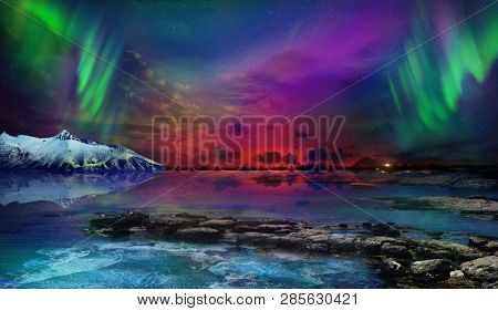 Beautiful northern lights of the northern part of the planet. Magnificent views of the ocean and northern lights with rocks and stones. Beautiful sea water plays with colors and light