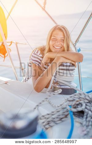 Girl On Board Of Sailing Yacht On Summer Cruise. Travel Adventure, Yachting With Child On Family Vac