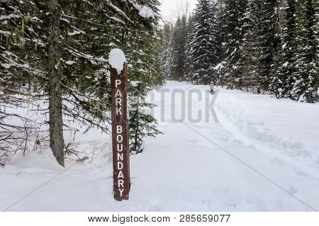 A Park Boundary Signpost Along A Wintery Hiking Path In The Snowy Forests Of Mount Fernie Provincial