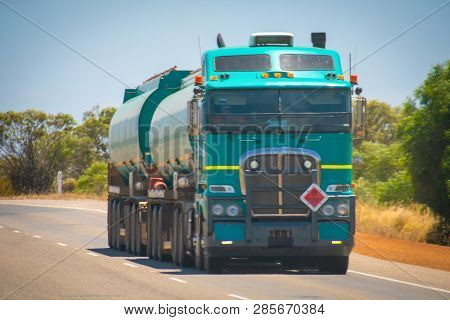 Long Road Train In The Australian Outback With Trailer Bringing Fuel To Gas Station