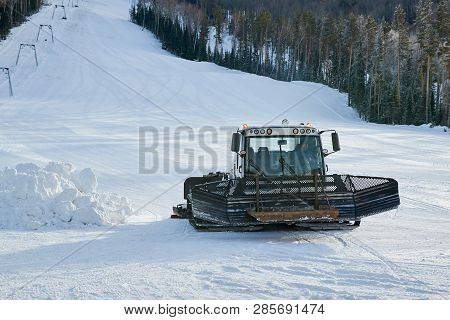 Snowcat On The Mountain Frosty Winter Day. Snowcat Is Equal To Snow On A Ski Slope In A Ski Resort.