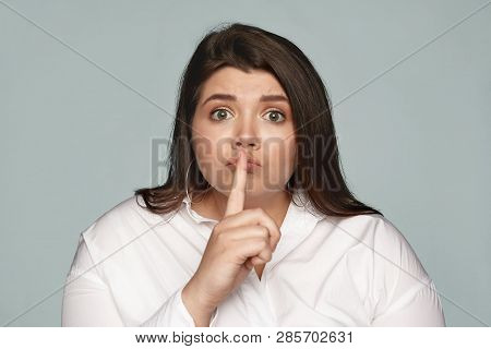 Emotional Bug Eyed Overweight Young Female Secretary In White Formal Shirt Keeping Index Finger At H