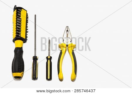 Tools On Grey Background Pliers And Screwdriver Set.