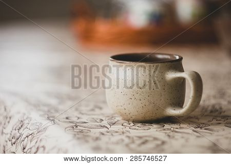 Cup Of Herbal Tea At Table In Garden