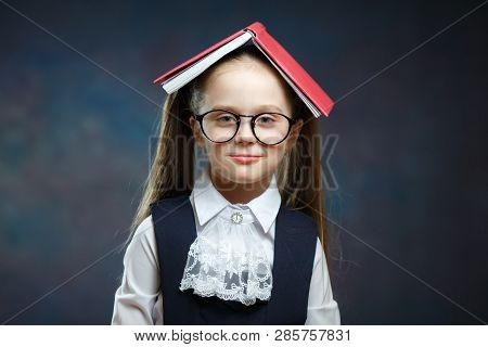 Cute Schoolgirl Shout Cover Head With Open Book. Closeup Portrait Of Elementary School Student Scree