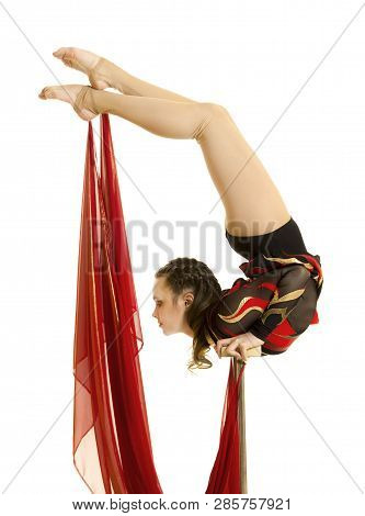 Flexible Equilibrist Performs Exercises On Acrobatic Walking Sticks.