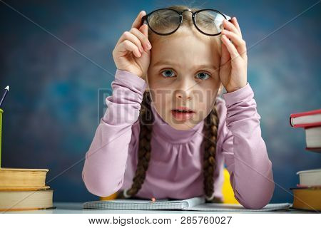 Pretty Little Primary Student Girl Study Home. Nice Causasian Child Look Attentively Do Homework. Cu