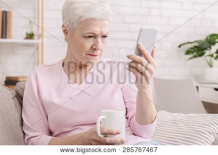 Myopia. Senior Woman Holding Phone Near Face, Trying To See Message, Free Space