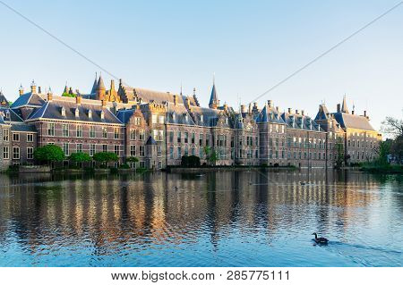 Facade Of Binnenhof - Dutch Parliament With Reflections In Pond Still Water, The Hague, Holland